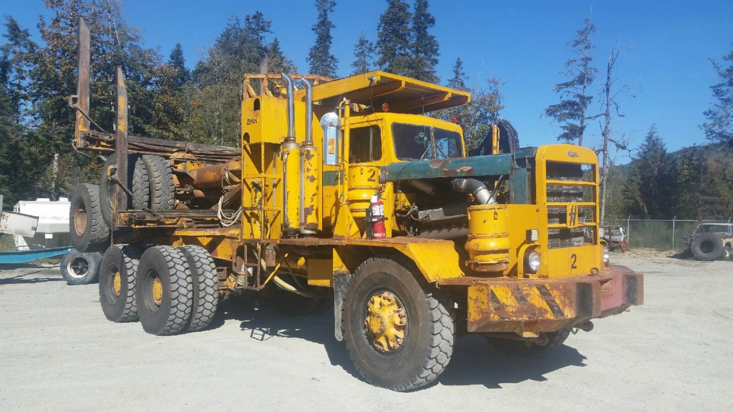 HAYES HDX LOGGING TRUCK GM V12 C/W 13 SPEED - 91000 LB PLANETARY READ ENDS AND 12 FOOT LOGGING BUNKS AND TRAILER
